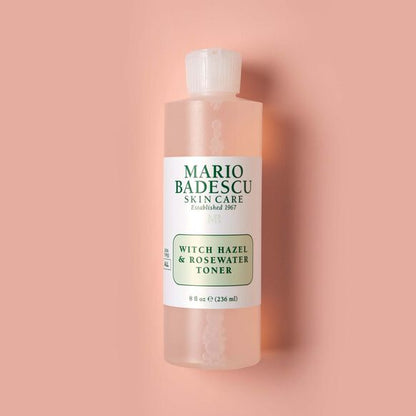 Mario Badescu witch hazel and rosewater toner bottle on a pink background