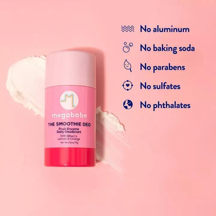 Megababe The Smoothie Deo Fruit Enzyme Daily Deodorant on a pink background with labels for no aluminum, parabens, and phthalates.
