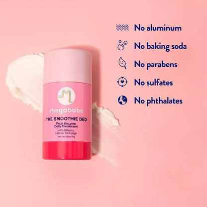 Megababe The Smoothie Deo Fruit Enzyme Daily Deodorant on a pink background with labels for no aluminum, parabens, and phthalates.