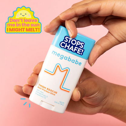 Hand holding a 'megababe' anti-chafe stick with a pink background and text.