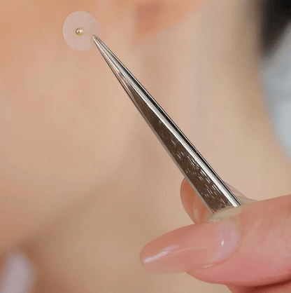 Muihood 24K Gold Plated Ear Seed Kit showcasing ear seed application with tweezers for wellness.