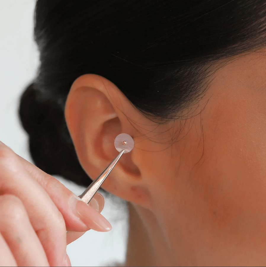 Applying Muihood 24K Gold Plated Ear Seed Kit for acupressure and wellness.