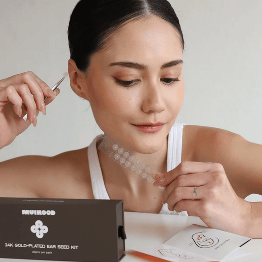 Muihood 24K Gold Plated Ear Seed Kit displayed with a user applying ear seeds, showcasing wellness and luxury.