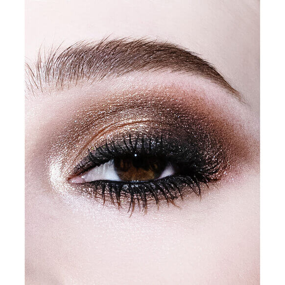 Close-up of a dramatic eye makeup look featuring shimmery bronze and dark shades using NARS Extreme Effects Eyeshadow Palette.