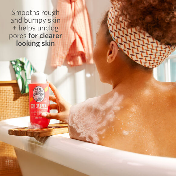 Sol de Janeiro Bom Dia Bright Clarifying AHA BHA Body Wash in use, promoting smoother skin and clearer pores.