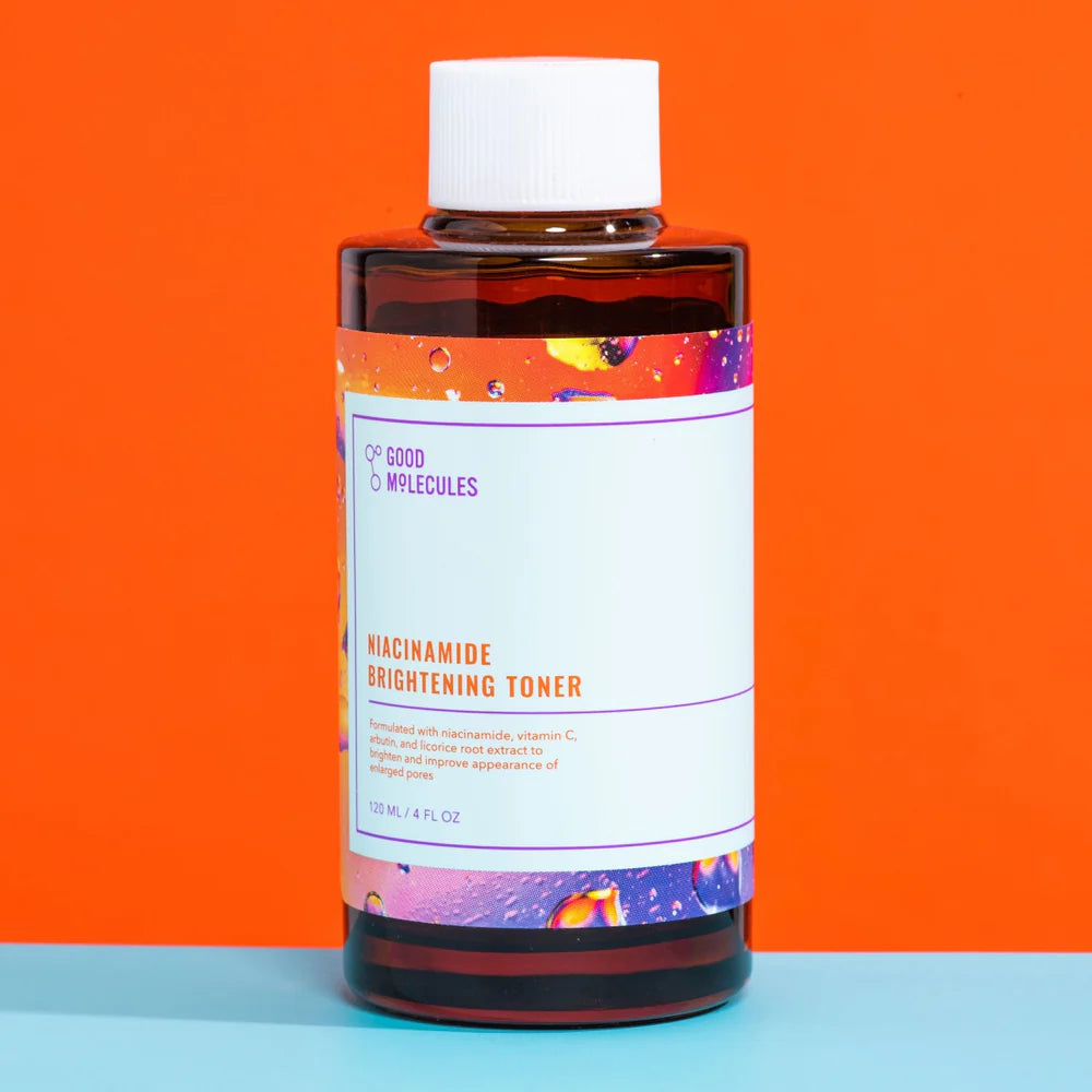 Bottle of niacinamide brightening toner with a colorful label on an orange and blue background
