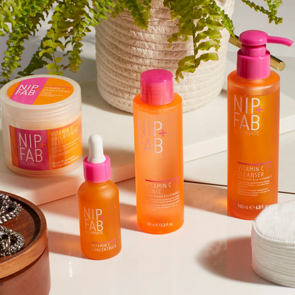 Nip & Fab skincare products on a light surface with plants in the background