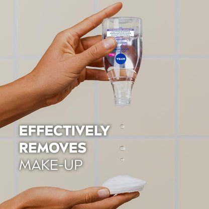Hand holding a NIVEA  bottle labeled 'Vegan' with text 'Effectively Removes Make-Up' on a tiled background.
