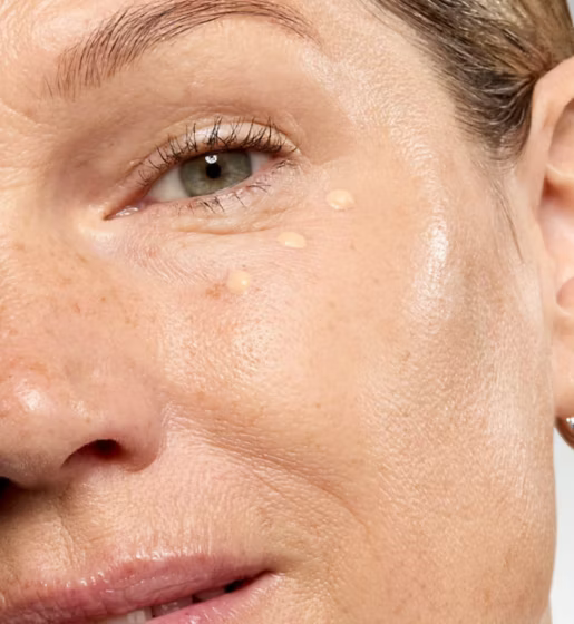 Close-up of a woman's face with visible skin texture and pores.