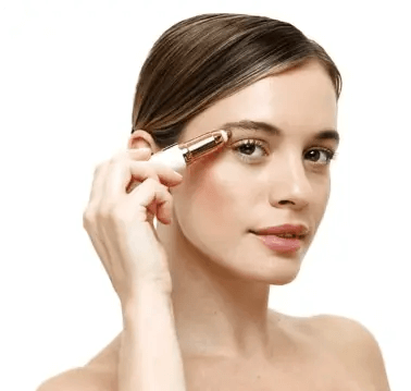 Woman using Nu You Eyebrow Shaper, a precision hair removal tool in 18 karat gold plate.
