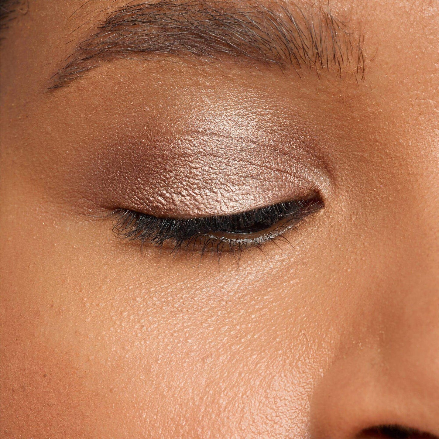 Close-up of an eye wearing NUDESTIX Magnetic Luminous Eye Colour in Burnish, showing a satin finish and vibrant color.