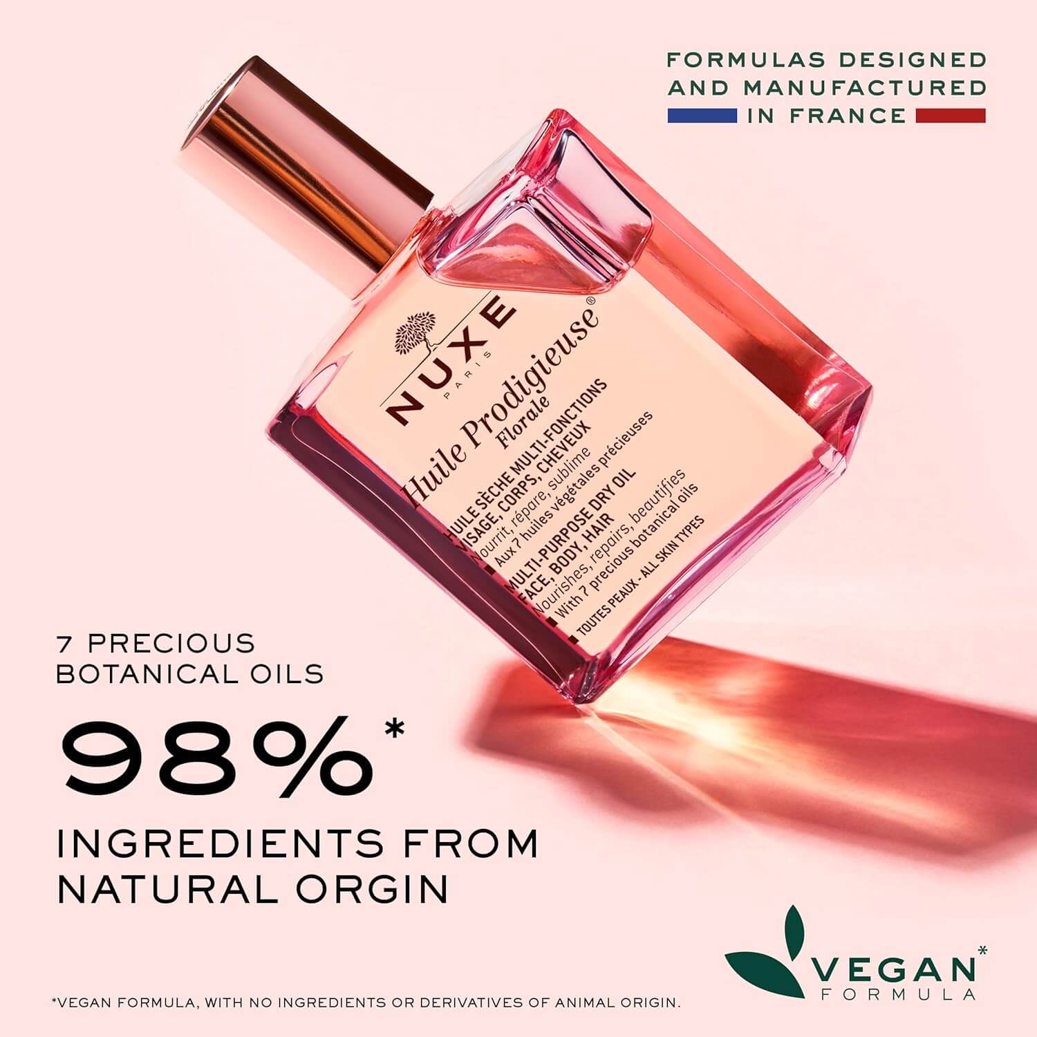 Nuxe perfume bottle with product details on a pink background