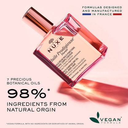 Nuxe perfume bottle with product details on a pink background