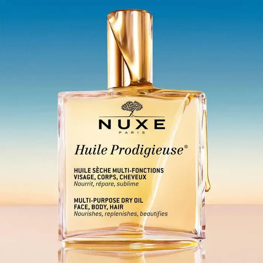 Nuxe Huile Prodigieuse multi-purpose dry oil bottle on a gradient background