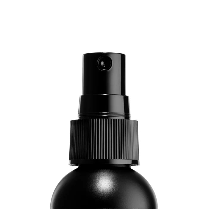 NYX Black spray bottle on a white background
