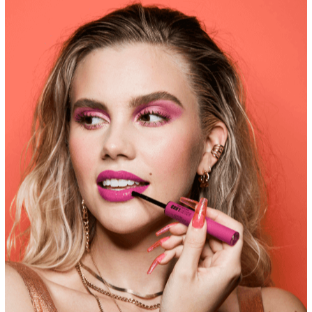 Model applying NYX Professional Makeup Shine Loud Lip Colour in vibrant pink shade with glossy finish.