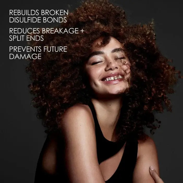 Woman with curly hair against a dark background with text about Olaplex hair care benefits.