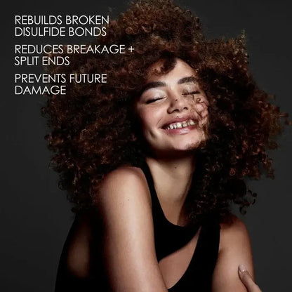 Woman with curly hair against a dark background with text about Olaplex hair care benefits.