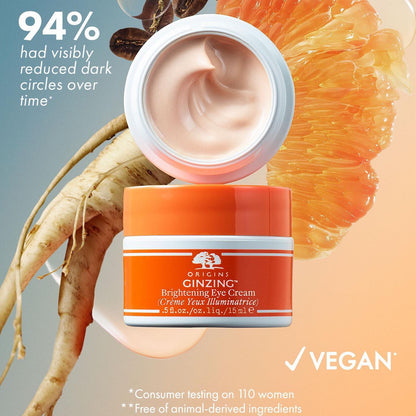 Origins Orange skincare jar with cream, coffee beans, and grapefruit on a gradient background