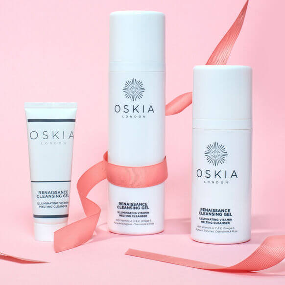 Oskia skincare products on a pink background with ribbons