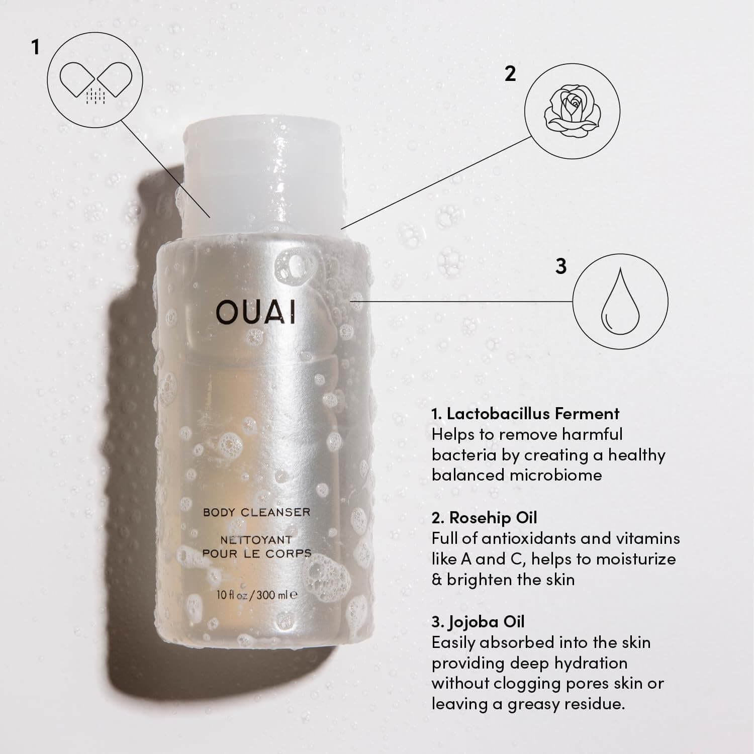 OUAI body cleanser bottle with features labeled on a light background