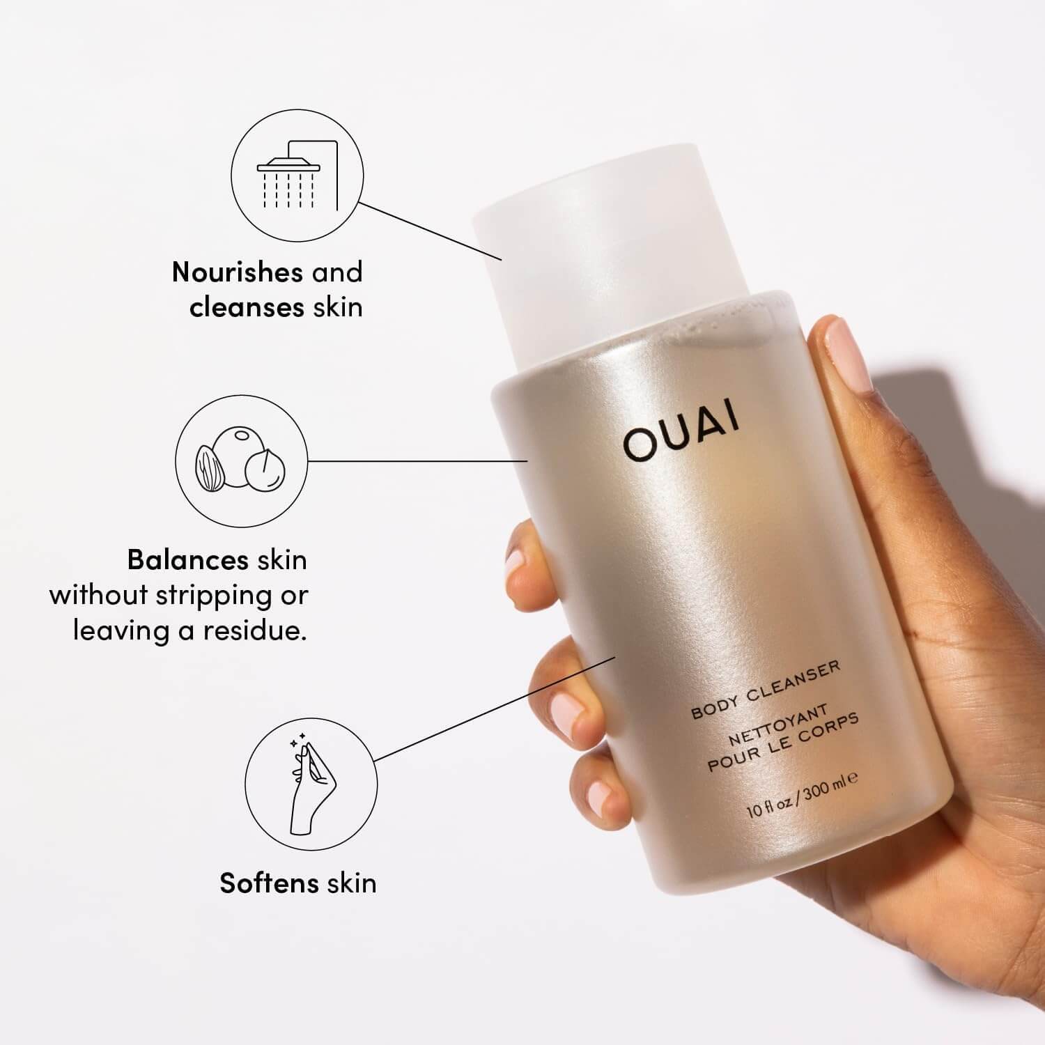 OUAI body cleanser bottle held by a hand with product benefits text on a white background