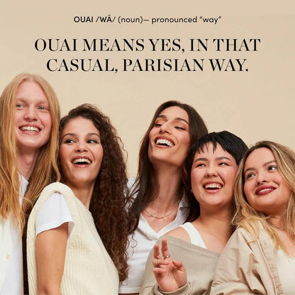 Five women laughing together with the OUAI brand name and definition above them on a beige background.