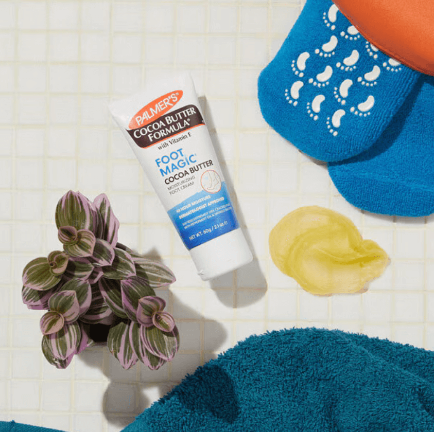 Palmer's Cocoa Butter Formula Foot Magic 60g with peppermint oil, surrounded by soothing foot care accessories.