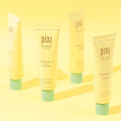 Pixi Vitamin-C Lotion bottles on a yellow background