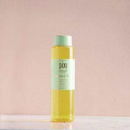 Pixi Vitamin C Tonic bottle on a light pink background