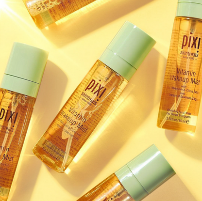 PIXI Vitamin Wakeup Mist bottles on a yellow background