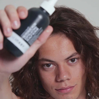 Male model showcasing The INKEY List hair product with a focus on healthy hair and vibrant style.