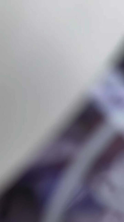 Blurry image of Sol de Janeiro Delicia Drench Shower Oil packaging emphasizing luxury and hydration.