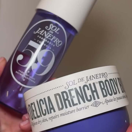 Sol de Janeiro Delicia Drench Body Butter and body care products in a person's hands.
