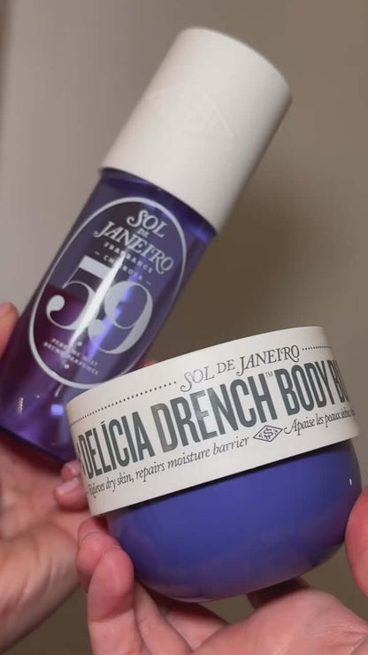 Sol de Janeiro Delicia Drench Body Butter and body care products in a person's hands.