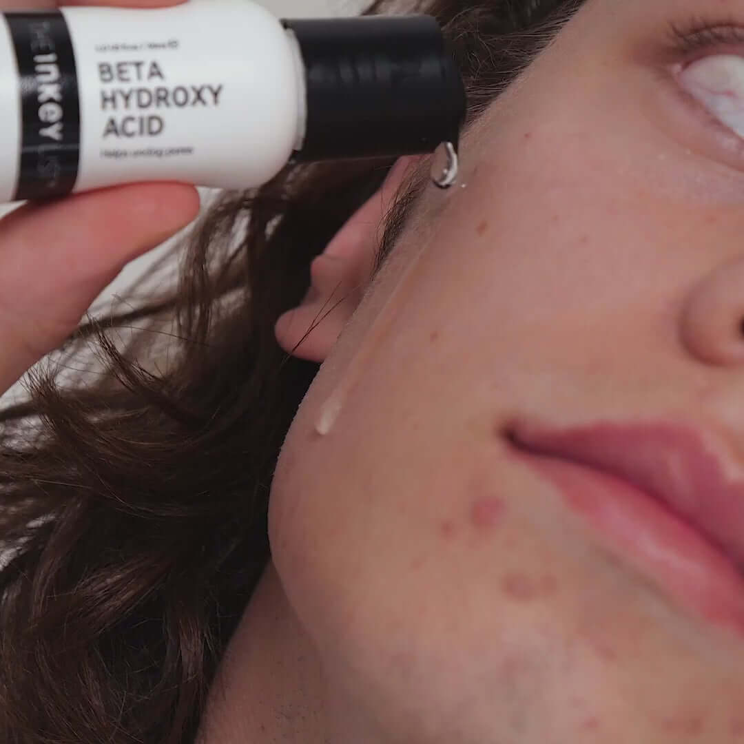 Man applying The INKEY List Beta Hydroxy Acid Serum to his face for clearer, smoother skin.