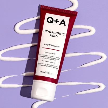 Tube of Q+A Hyaluronic Acid moisturizer on a purple background with white swirls