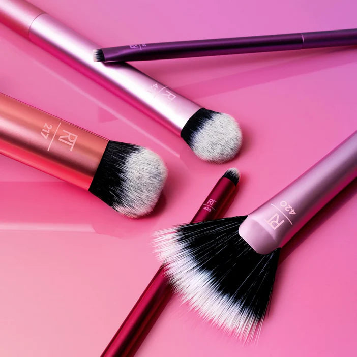 Real Techniques Artists Essentials makeup brush set featuring five professional-grade tools on a gradient background.