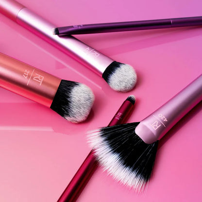 Real Techniques Artists Essentials makeup brush set featuring five professional-grade tools on a gradient background.