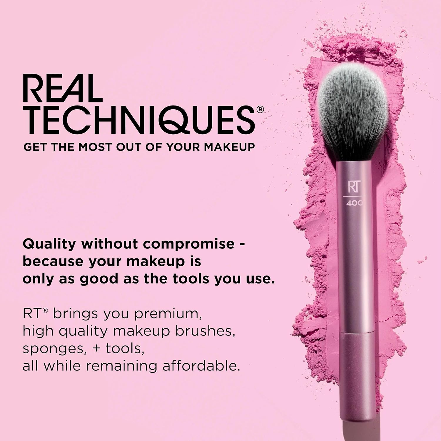 Makeup brush with pink handle and gray bristles on a pink background, featuring Real Techniques branding.