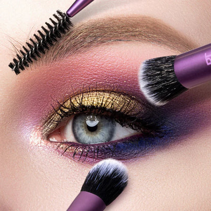 Close-up of a person applying makeup with a purple brush on their eye.