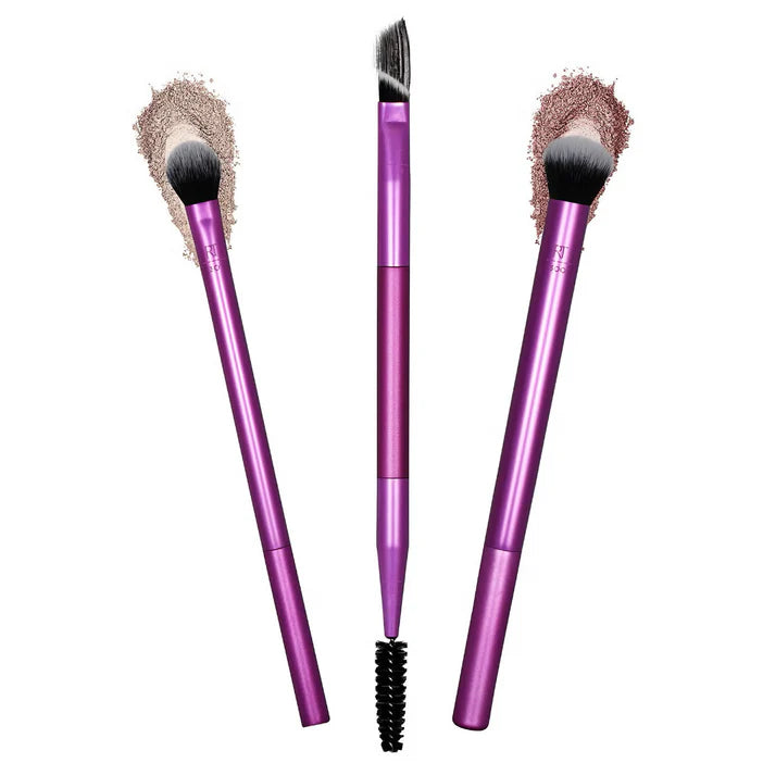 Three purple makeup brushes with different bristle types on a white background