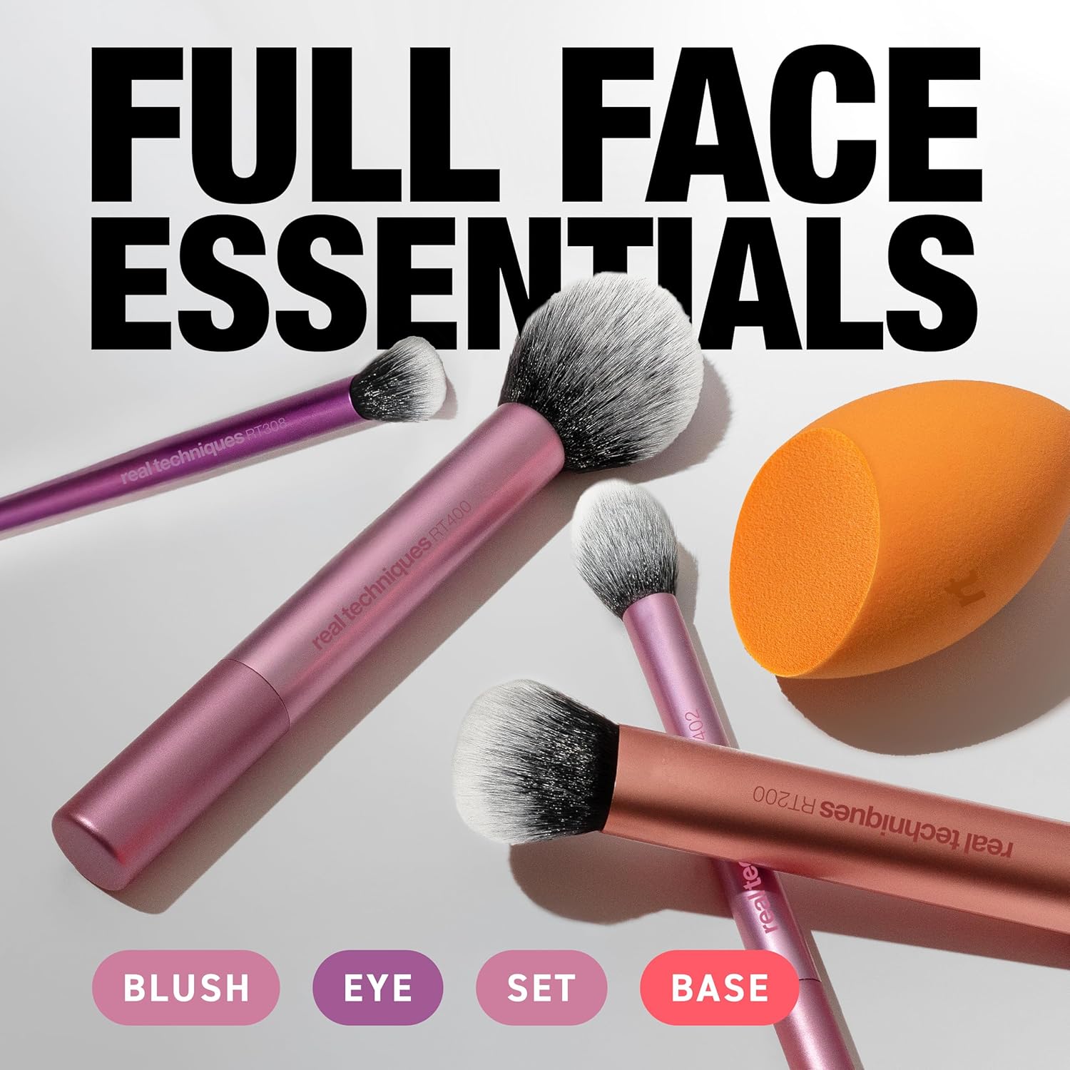 Real Techniques Makeup brushes and an orange sponge with text 'Full Face Essentials' on a white background.