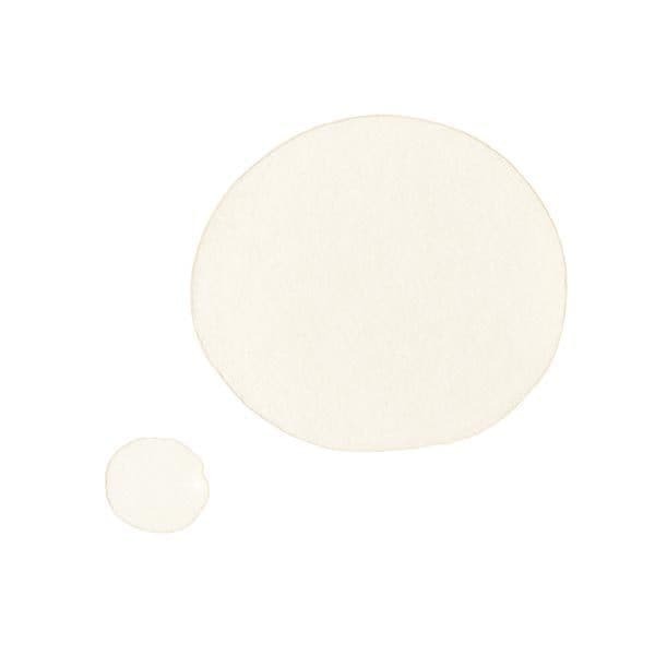 White circles of Revolution Baking Oil showcasing its silky-smooth texture for radiant skin before makeup application.