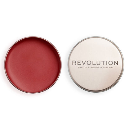 Revolution Lip & Cheek Balm Glow in a sleek round tin open to reveal a creamy red shade for a dewy finish.