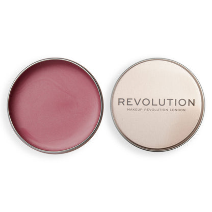 Revolution Lip & Cheek Balm Glow in a metal tin, showcasing a creamy blush for a dewy finish.