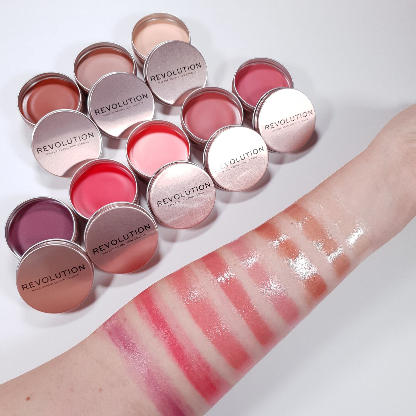 Revolution lip products with swatches on a white background