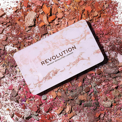 Makeup Revolution palette on a colorful powder background