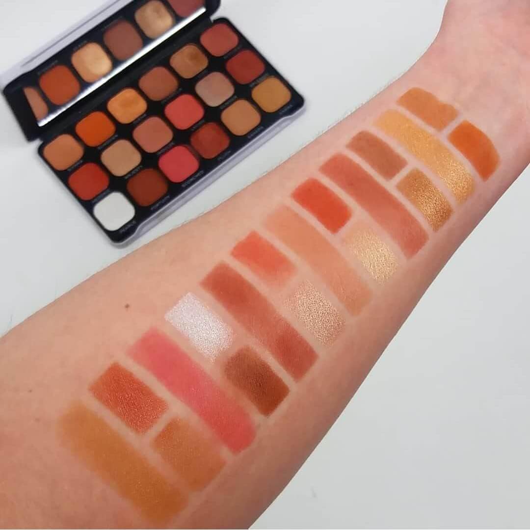 Revolution Makeup palette with swatches on a arm against a white background