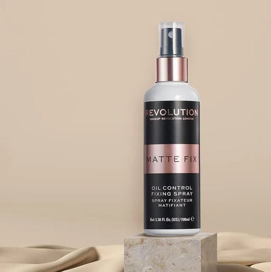 Makeup Revolution Matte Fix oil control fixing spray on a beige background